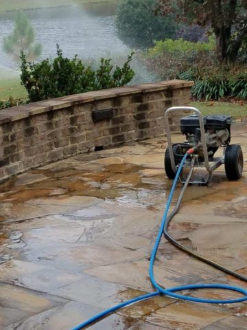stone patio being pressure washed