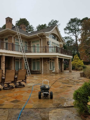 large view of stone patio being pressure washed